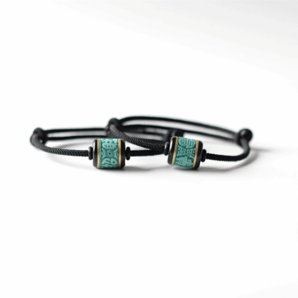Set of two good luck charm bracelets for couples or best friends, with adjustable cords and matching turquoise-style beads.